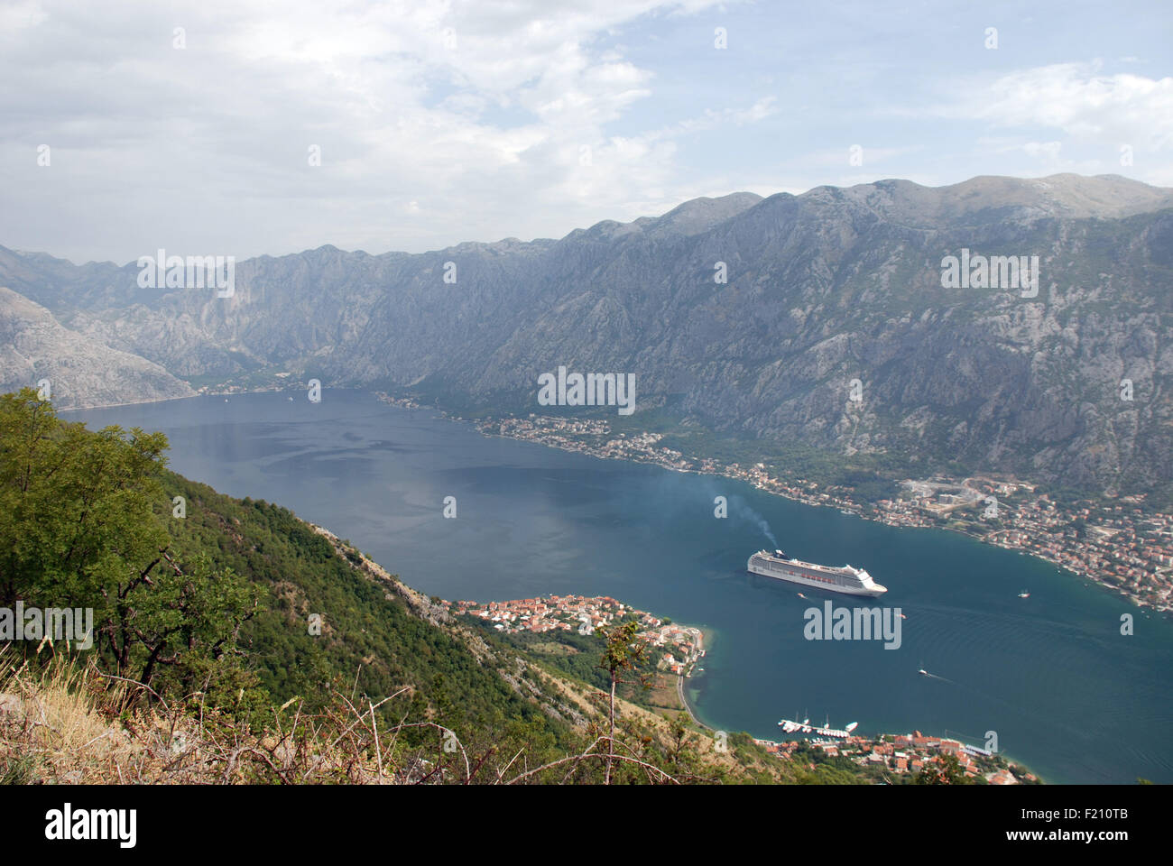 A large cruise ship in  Kotor Bay outside the old town of Kotor in Montenegro with limestone mountains in the background Stock Photo