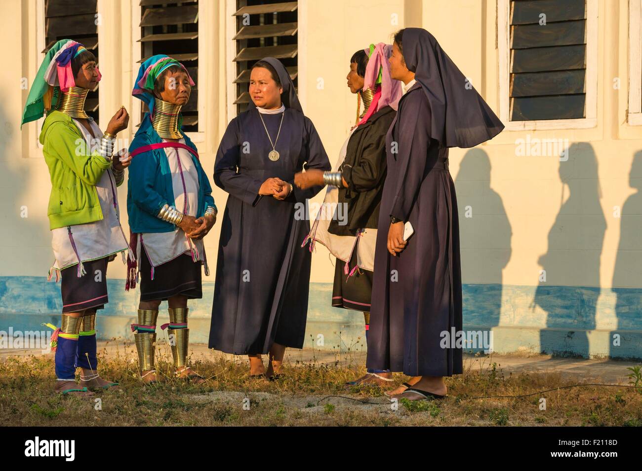 Myanmar (Burma), Kayah state, Kayan tribe (Padaung), Loikaw city, Christ the King Church, Moe Bu, Moe Ki and Moe Su, women named giraffe-women are discuting with catholic sisters Stock Photo