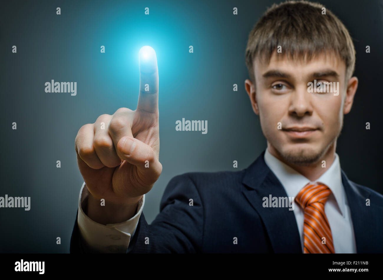 handsome businessman  finger point touch, on dark blue background Stock Photo