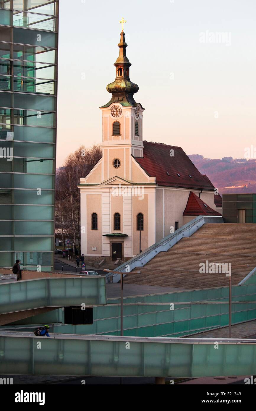Austria, Upper Austria, Linz, Sankt Jozef Church in front of Ars Electronica Center Stock Photo
