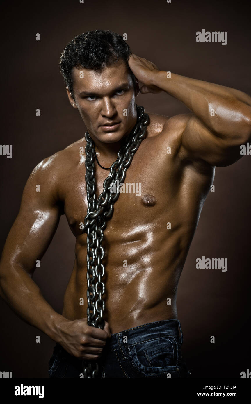 the very muscular handsome sexy guy on brown background, naked torso Stock  Photo - Alamy