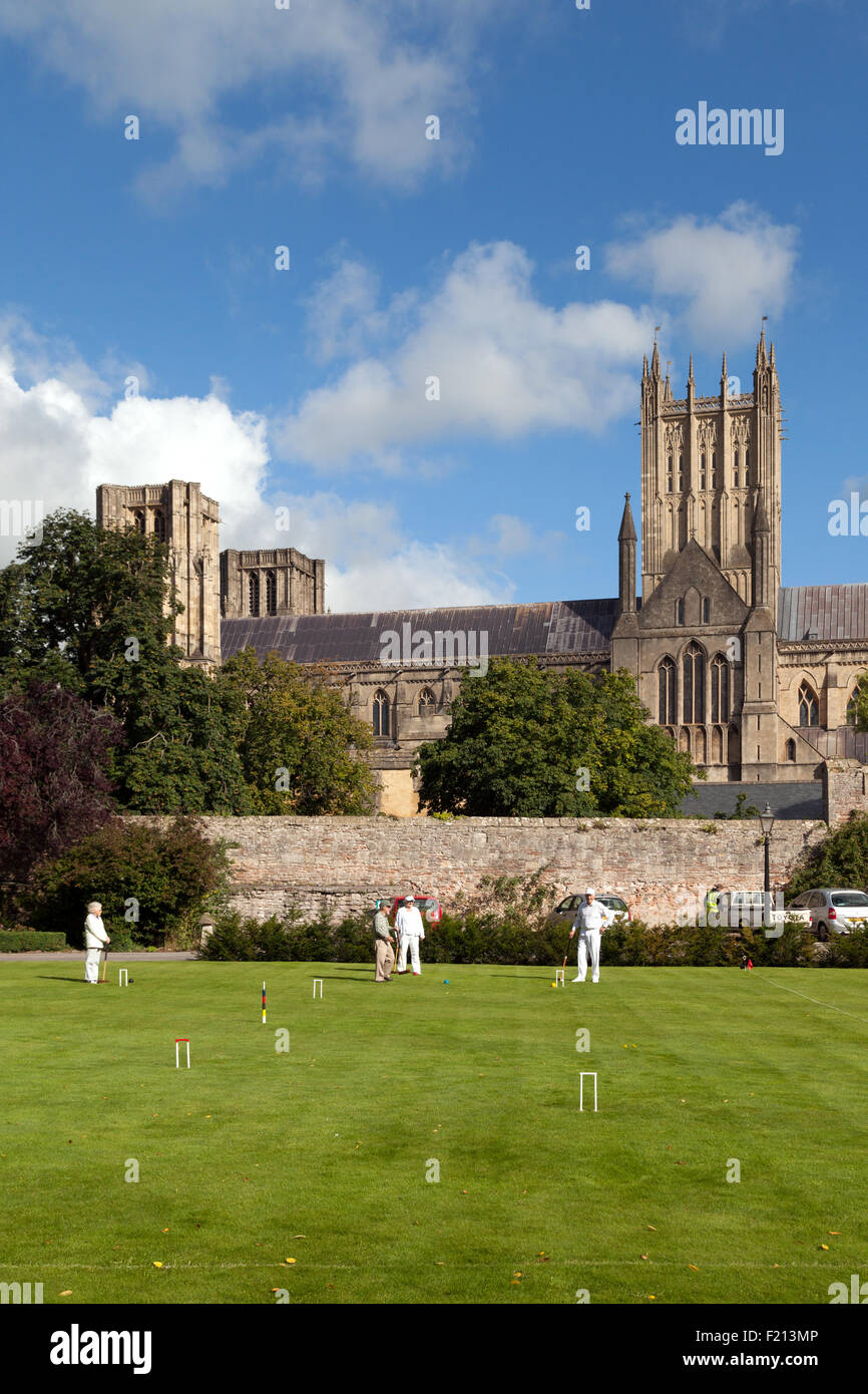 People playing croquet in the grounds of the Bishops Palace next to Wells Cathedral, Wells, Somerset England UK Stock Photo