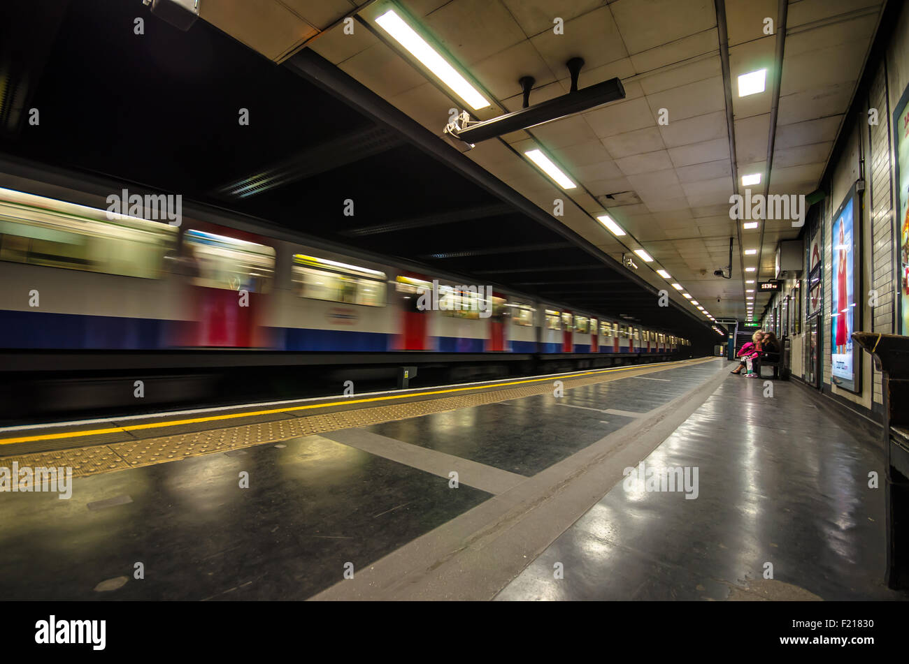 An underground train passing through St. James Park underground station. London underground, UK