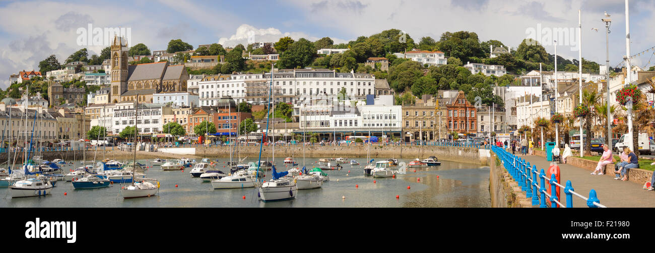 Torquay seafront with the boats moored in the harbour in a panoramic scene. Stock Photo