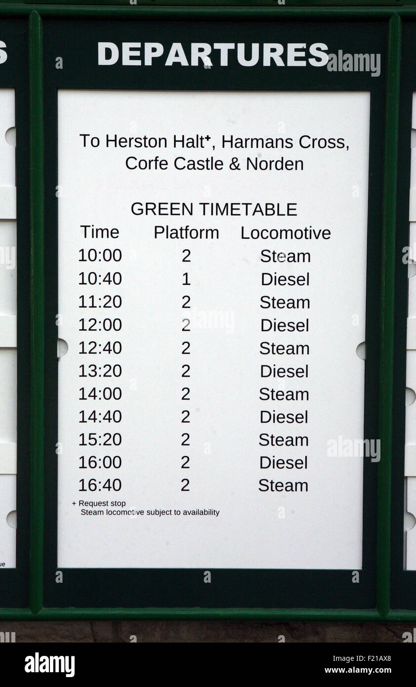 Departures notice timetable at train station Stock Photo
