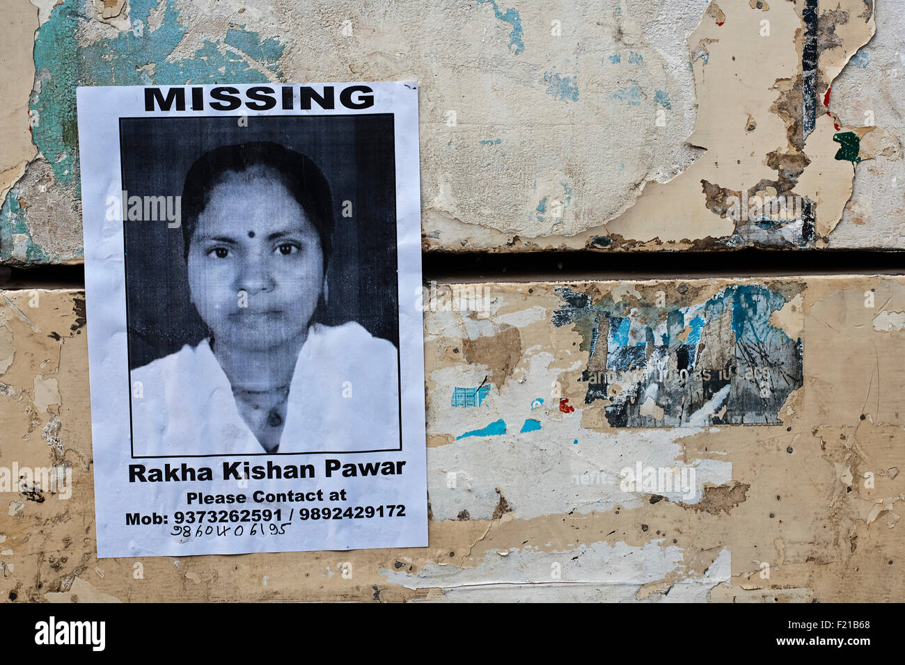 India, Maharashtra, Mumbai, Home-made poster for a missing woman stuck on a city-centre wall. Stock Photo
