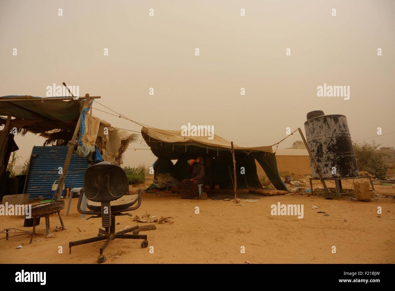Gaza, Gaza Strip. 9th Sep, 2015. A Palestinian woman is seen inside a tent during a dust storm after her house was destroyed during the 50-day Israeli war in the summer of 2014 in the village of Khuzaa, east of Khan Yunis, in the southern Gaza Strip, on Sept 9, 2015. © Yasser Qudih/Xinhua/Alamy Live News Stock Photo