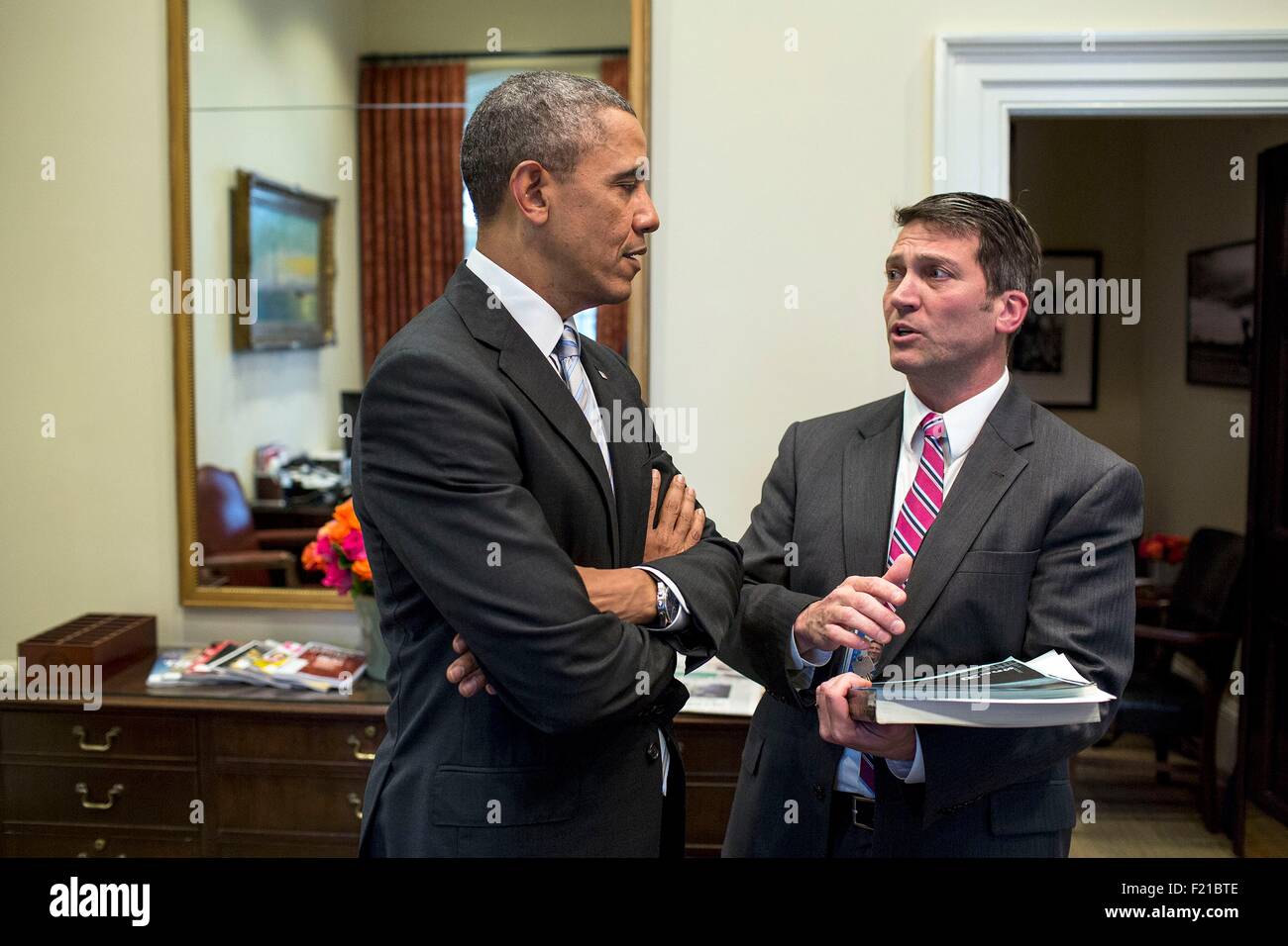 U.S. President Barack Obama speaks with his personal physician Dr. Ronny Jackson in the Outer Oval Office of the White House February 21, 2014 in Washington, DC. Stock Photo