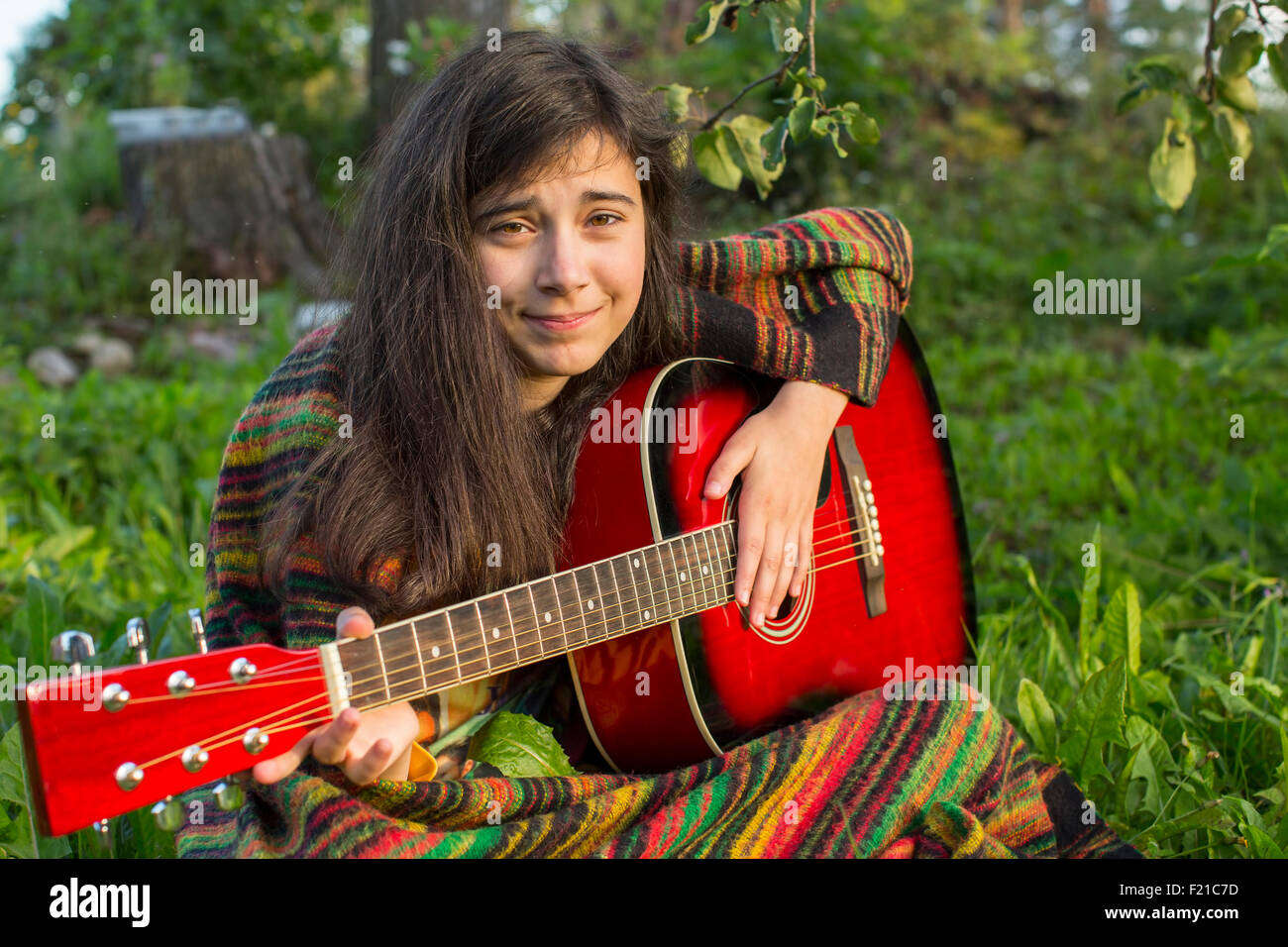 Young girl playing acoustic guitar outdoors Stock Photo - Alamy