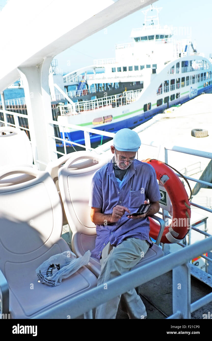 Man sitting on a ship Stock Photo