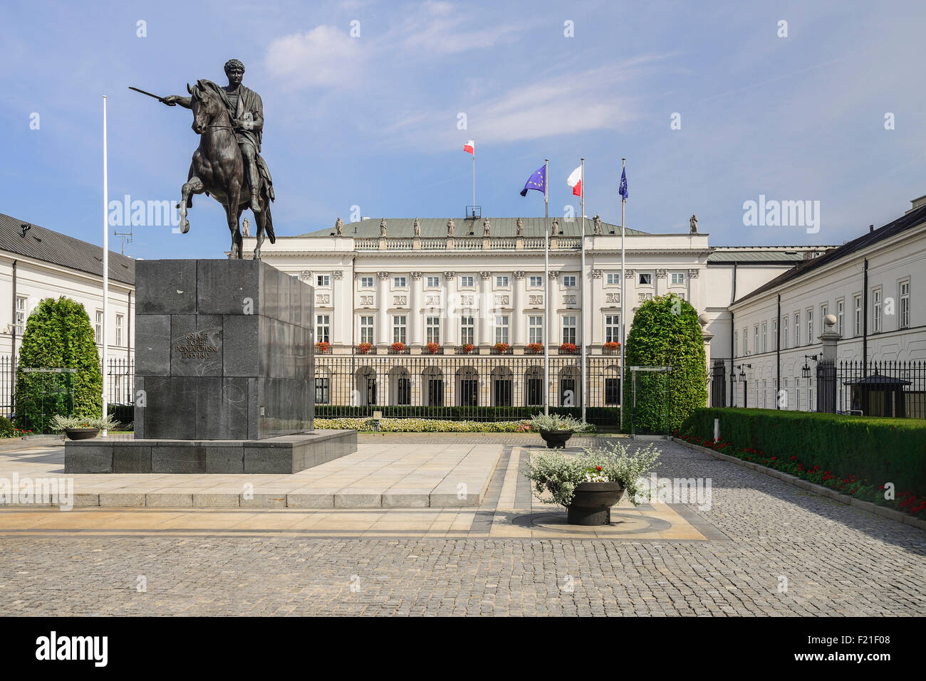 Poland Warsaw Ul Krakowskie Przedmiescie or The Royal Way Radziwill Palace Presidential Residence with a statue of Prince Stock Photo