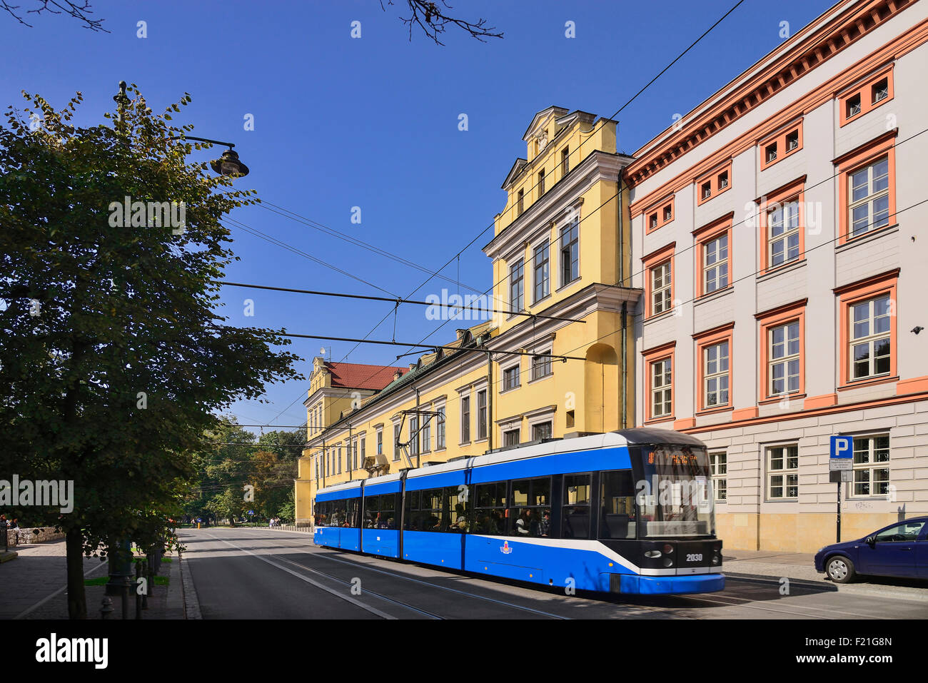 Poland, Krakow, Archbishop's Palace or Palac Biskupi, General view of the facade with city tram passing by. Stock Photo