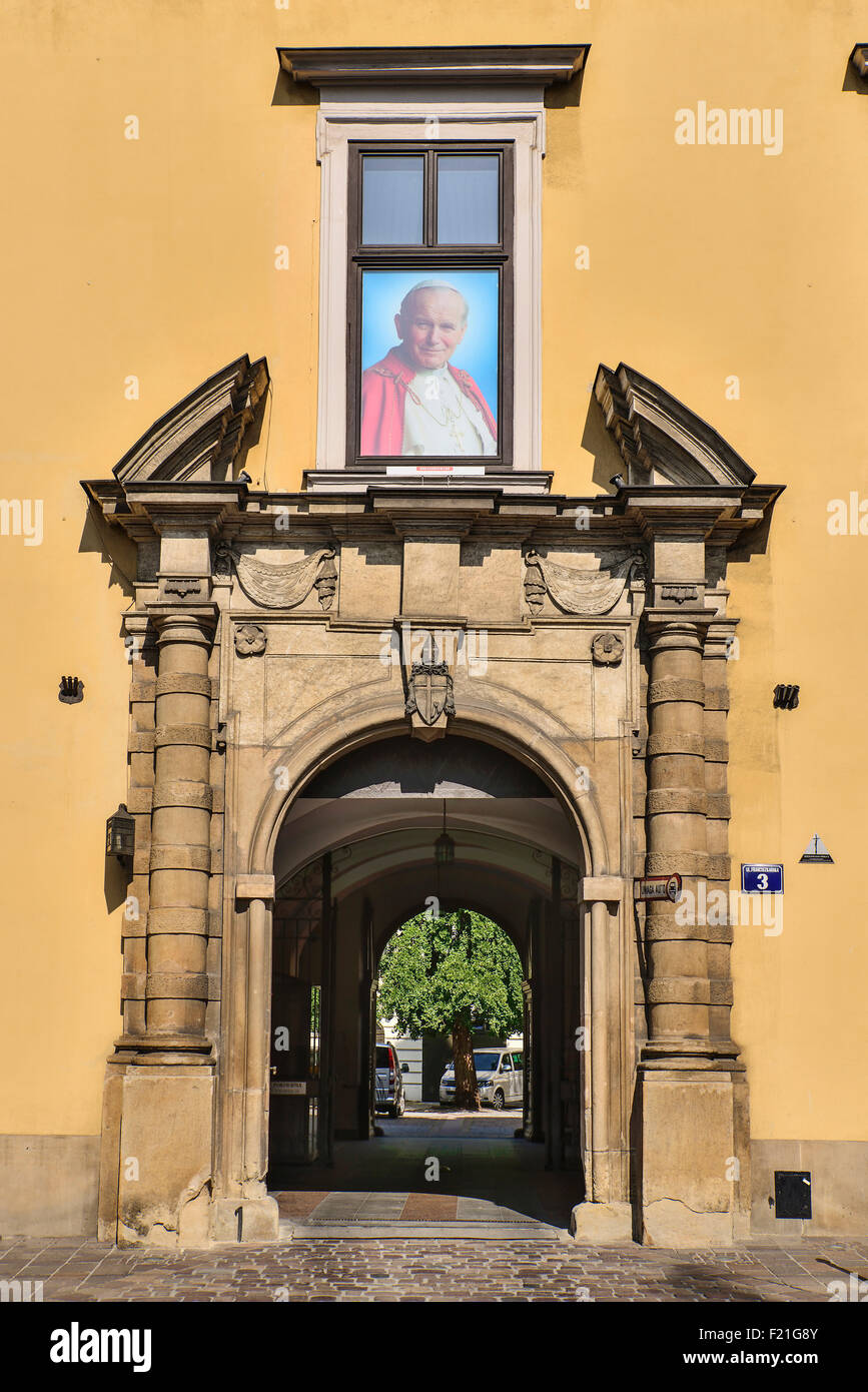 Poland, Krakow, Archbishop's Palace or Palac Biskupi, Palace entrance arch with picture of Saint John Paul 2nd above. Stock Photo