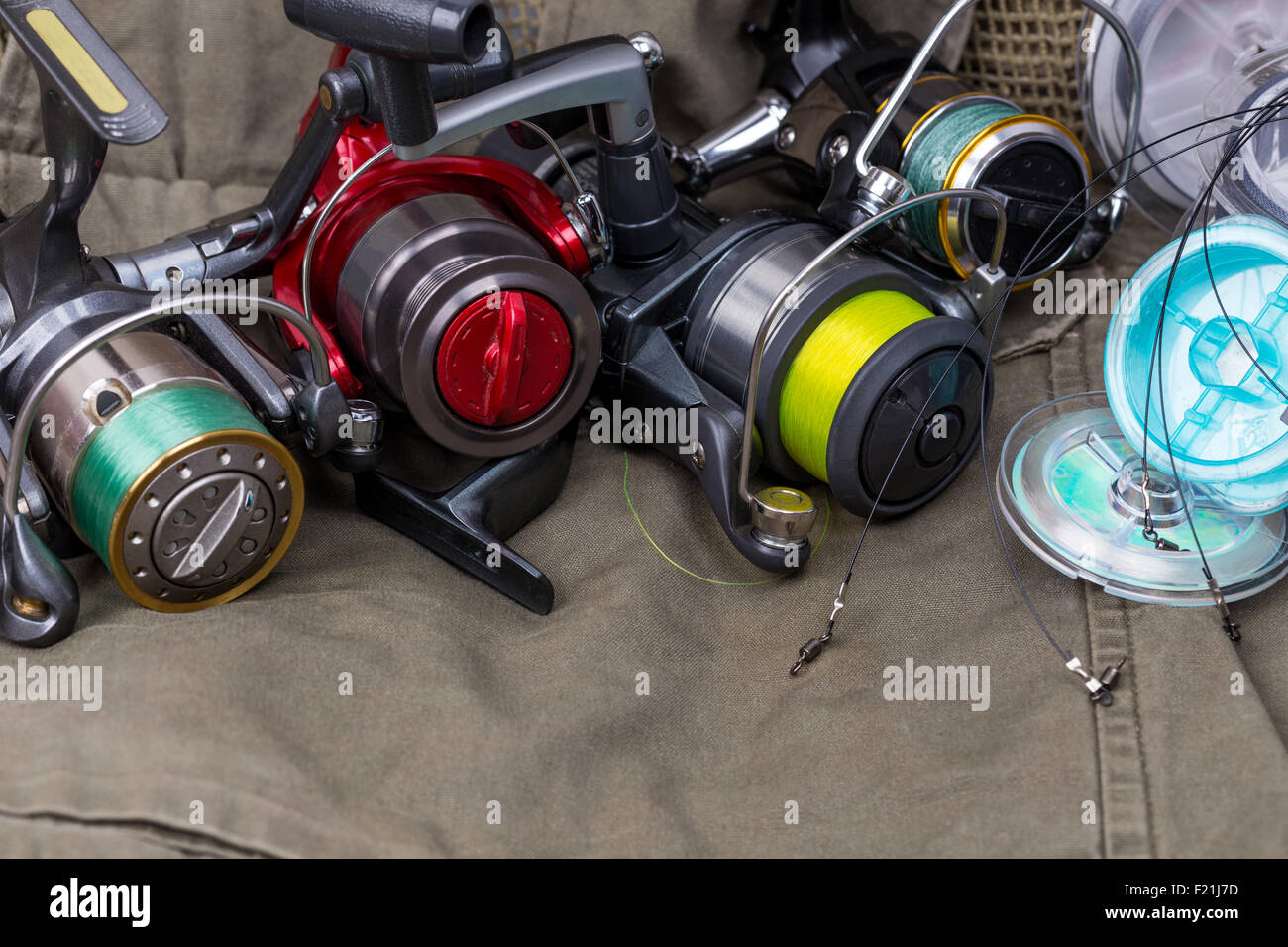 fishing reels with line different colors on cloth background Stock Photo