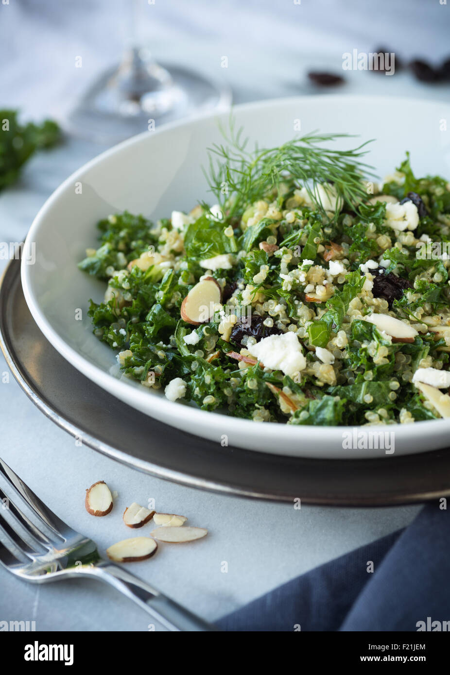 Kale and quinoa salad with dill vinaigrette and almonds Stock Photo