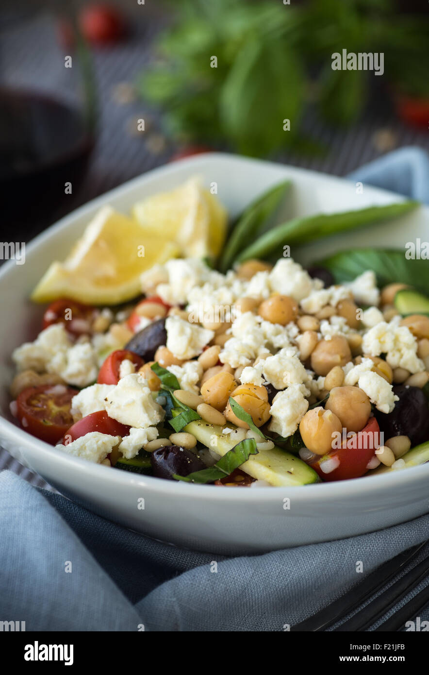 Vegetables and couscous salad with feta cheese and basil Stock Photo