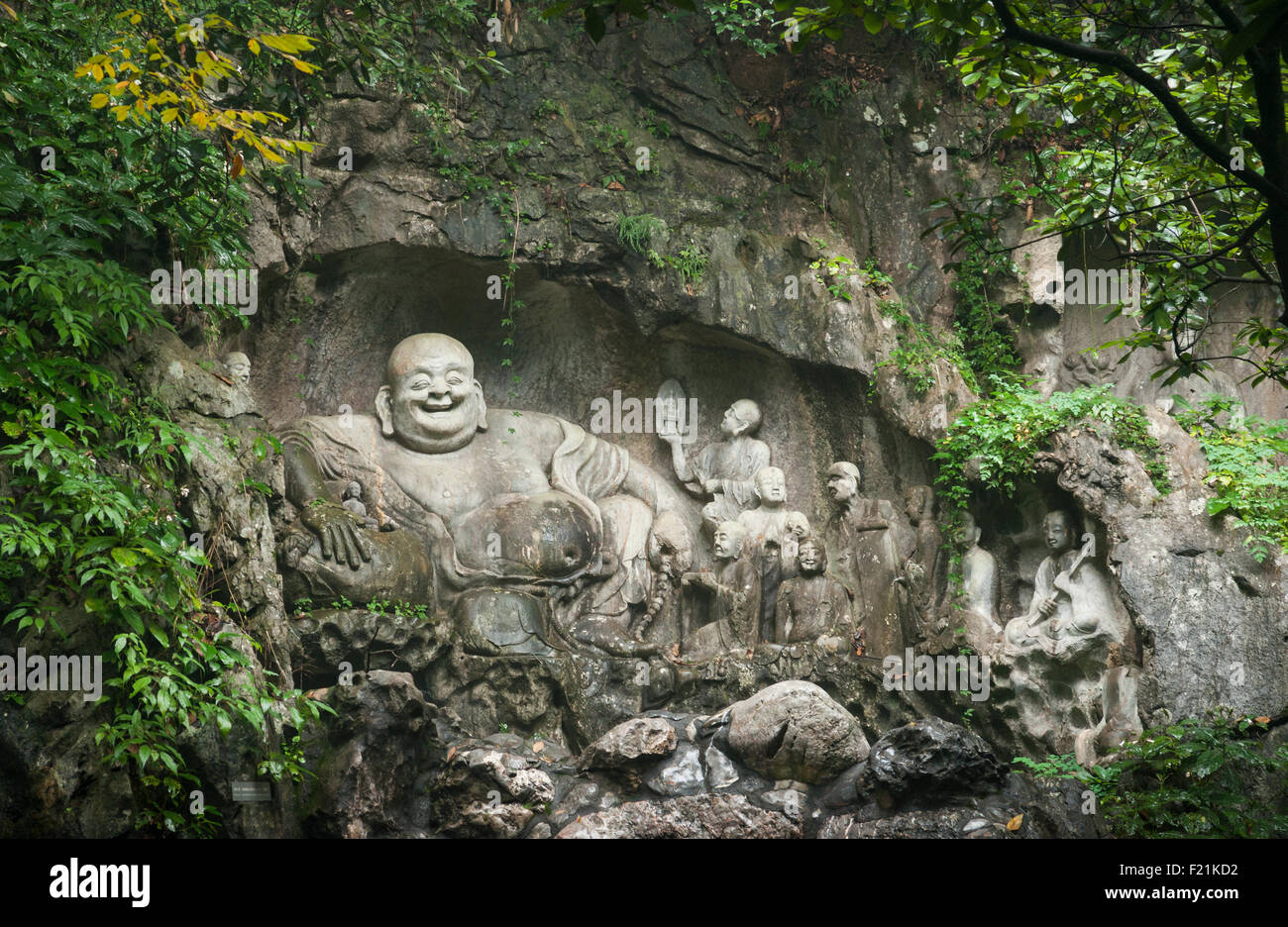 Buddha carved into rock face of Feilai Feng hill at Lingyin Temple, oldest Buddhist temple in China Stock Photo