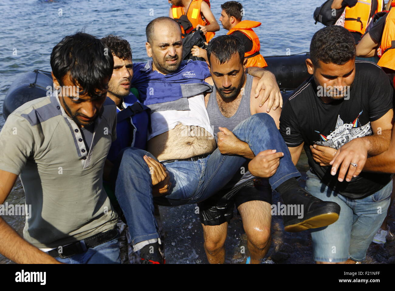 Lesbos, Greece. 9th September 2015. Refugees Carry An Injured Refugee ...