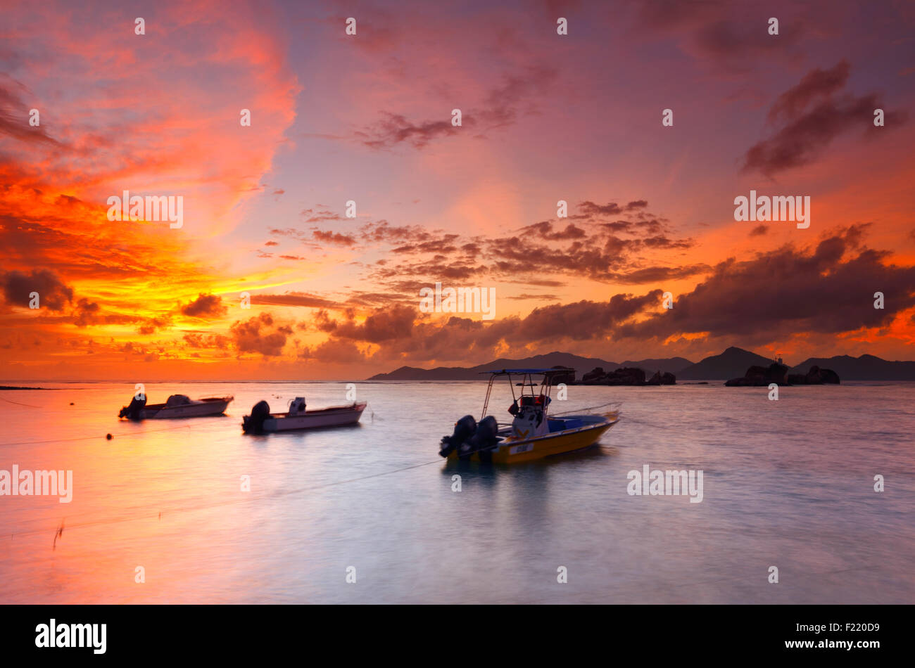 Colorful sunset on Seychelles with a beautiful clouds. Island La Digue. Stock Photo