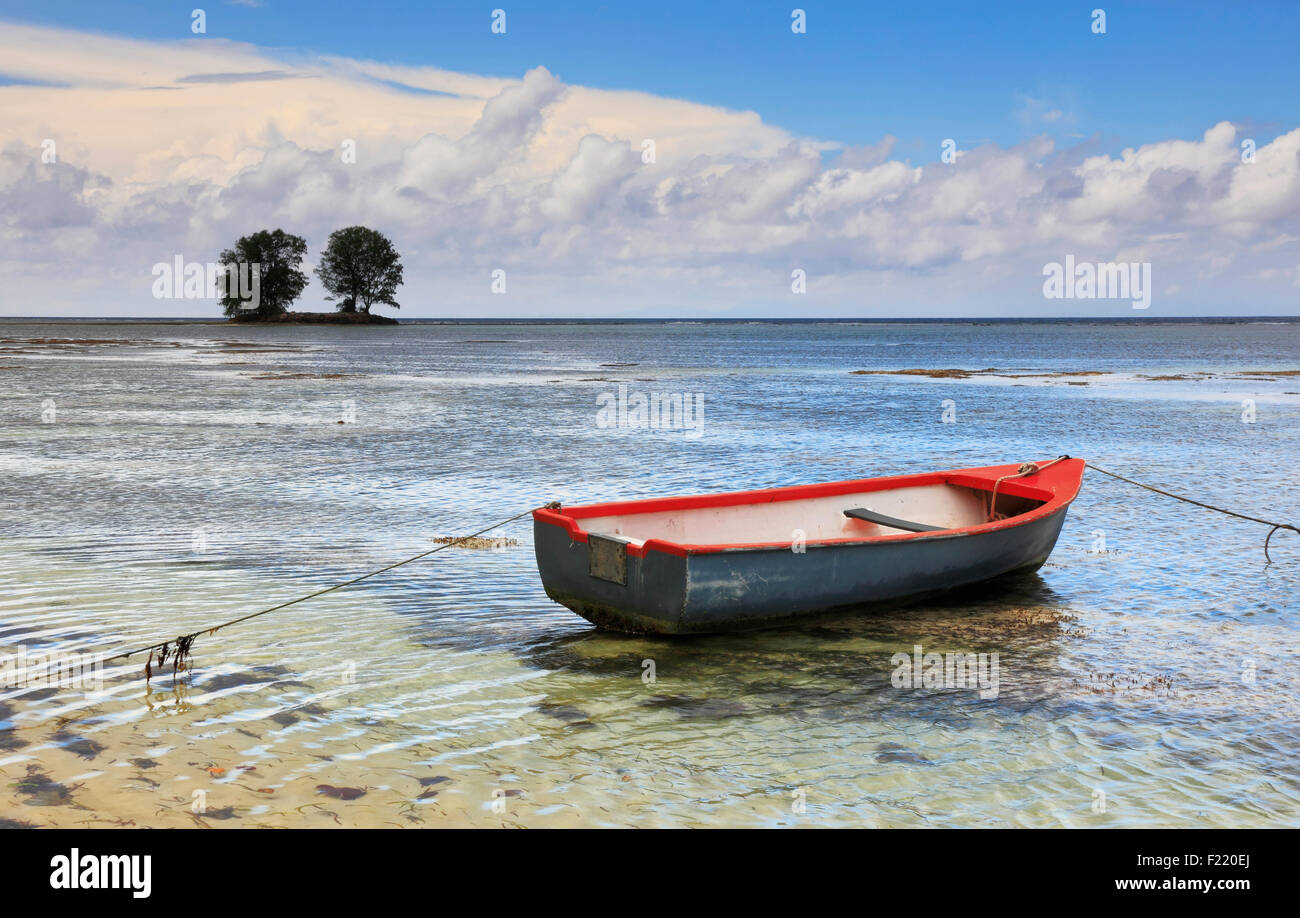 Boat in shallow sea on Seychelles Stock Photo Alamy