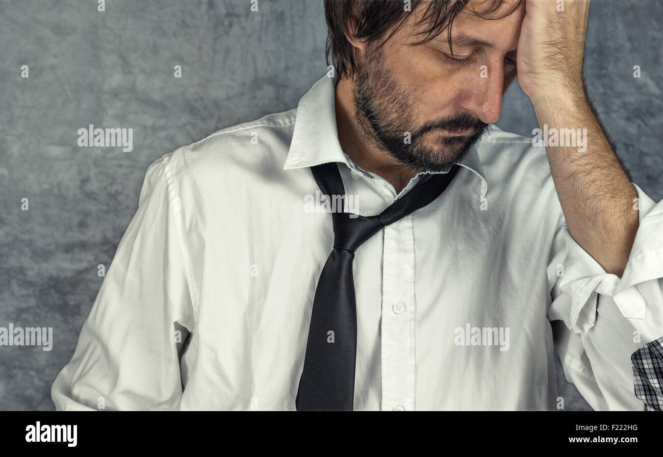 Portrait of tired exhausted businessman in trouble, problems in career Stock Photo
