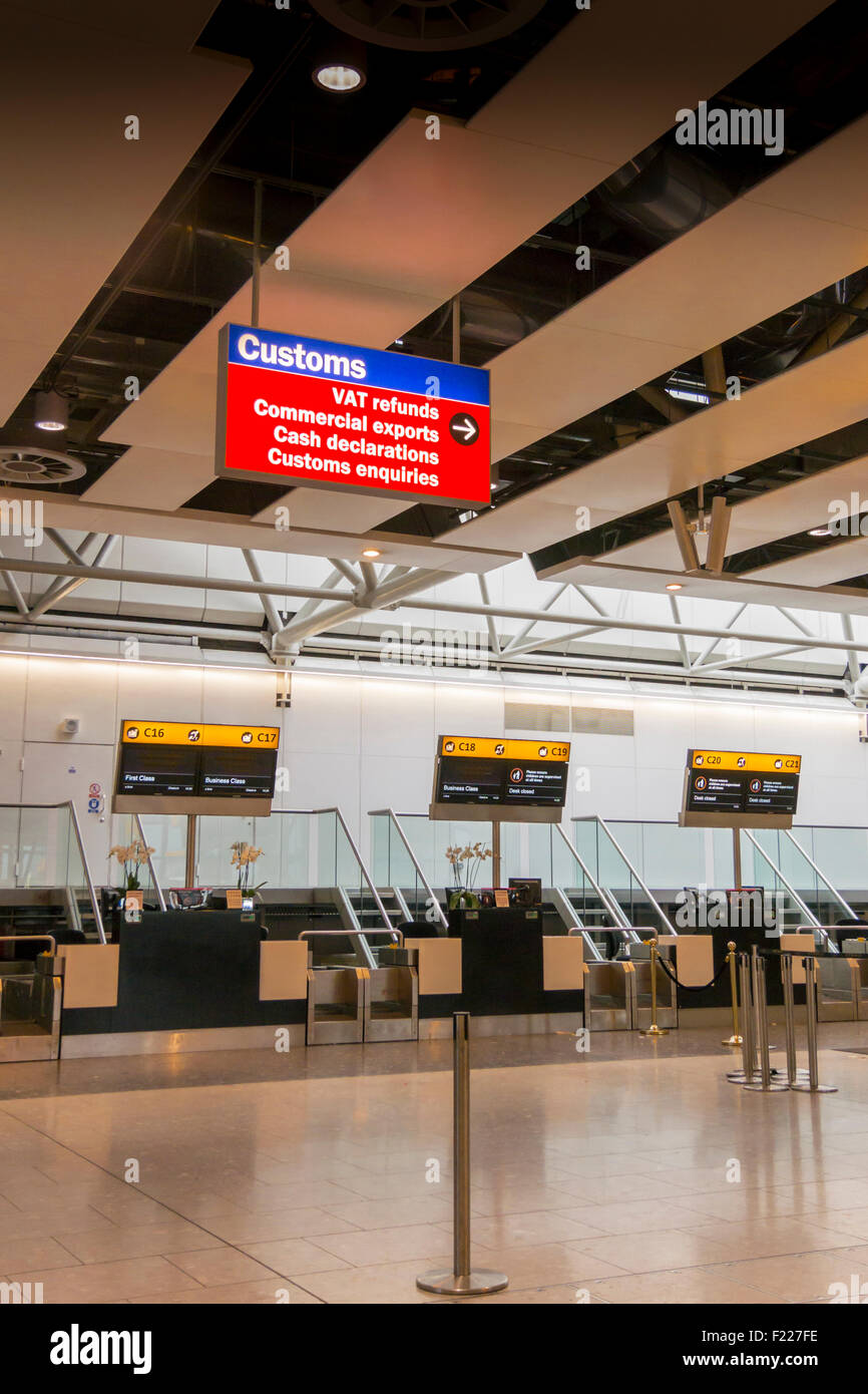 Closed check in desks and Customs sign at Heathrow airport Stock Photo
