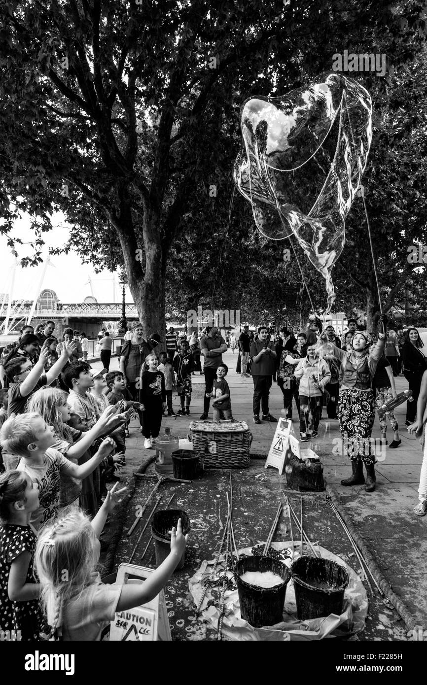 A Street Entertainer and Her Bubble Show, The Southbank, London, England Stock Photo