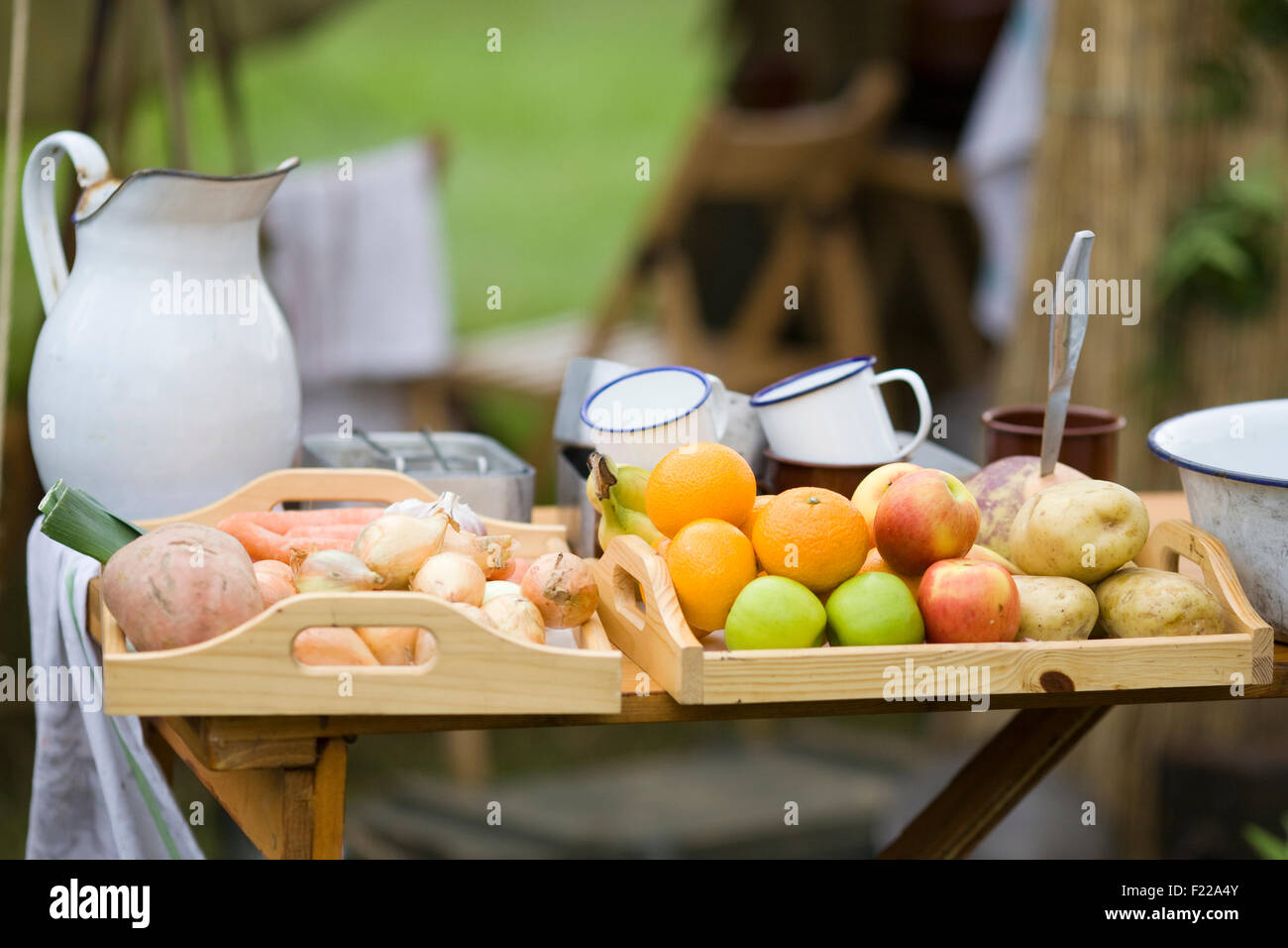 Table filled with fruit and vegetables in a military field kitchen Stock Photo