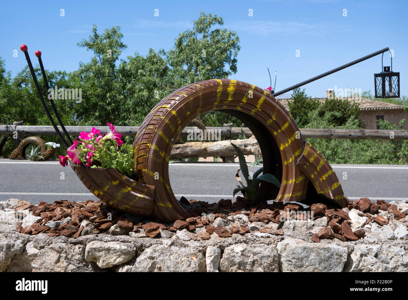 Decorative snails made of recycled tires. Stock Photo