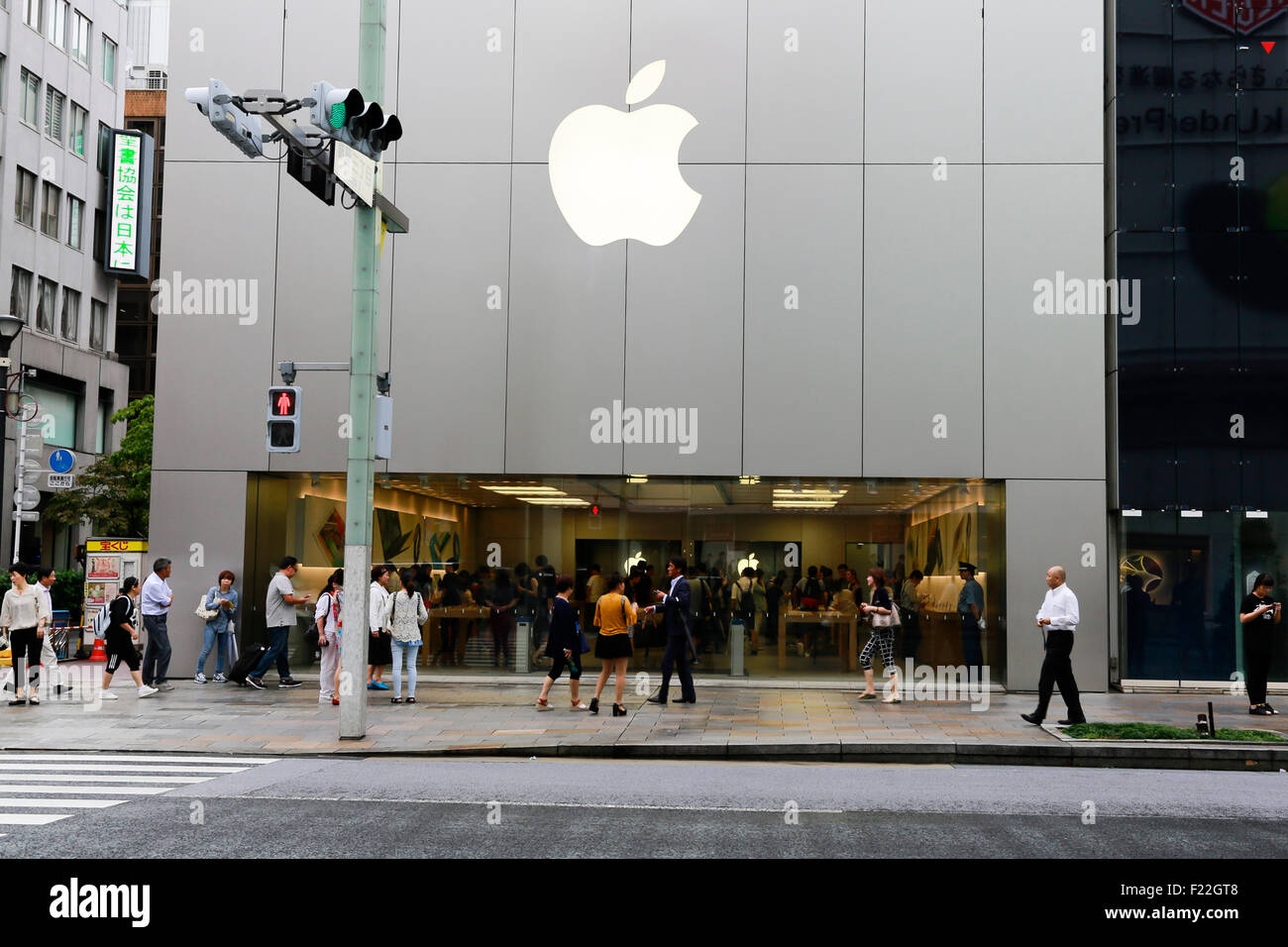 Pedestrians walk past the Apple Store in Ginza on September 10, 2015, Tokyo, Japan. Even after Apple CEO Tim Cook announced their new products iPad Pro, iPhone 6s, iPhone 6s Plus and Apple TV on September 9, 2015, hardcore Japanese fans were nowhere to be seen outside the principal stores in Ginza and Omotesando. This could be because of heavy rain that hit Japan this week caused by typhoon Etau, or perhaps Apple fans are now less excited by this clockwork new release cycle. In Australia the media already reported that the first Apple fan had set up a tent in front of the store in Sydney. (Pho Stock Photo