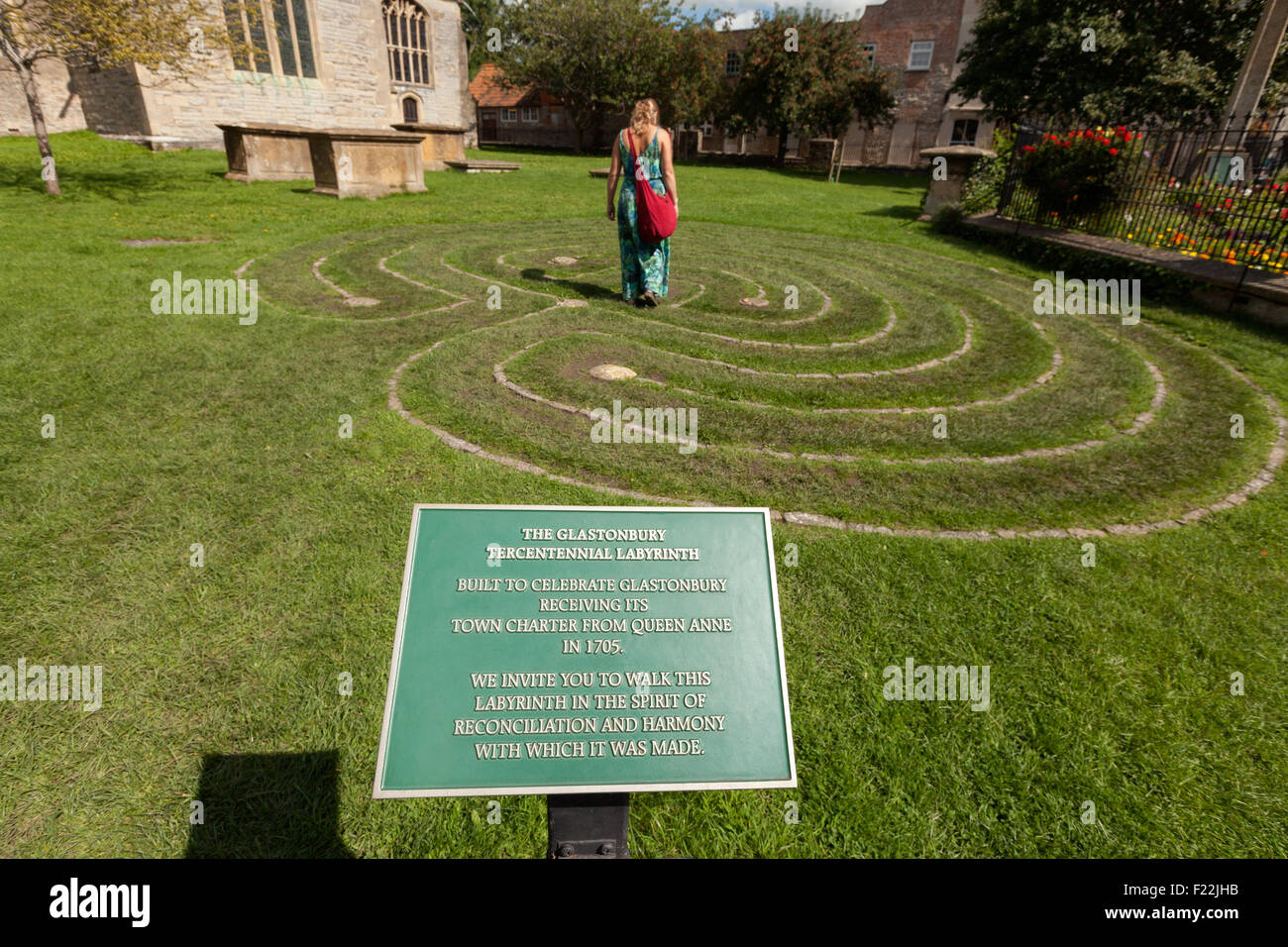 A woman walking the Glastonbury Tercentennial Labyrinth or Maze, the Church of St John the Baptist, Glastonbury Somerset UK Stock Photo