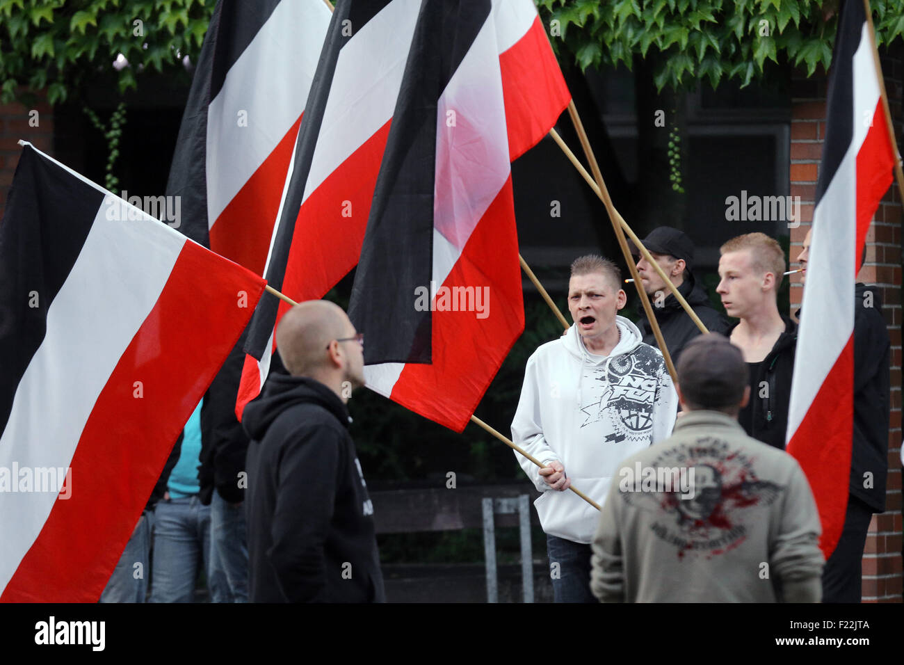 Supporters of the german far right neo-nazi party DIE RECHTE (the rights) waving the flag of the German Empire (Deutsches Reich) in Dortmund/Germany, Sept. 9th. 2015 in protest against the influx of migrants from Asia, Africa and the Middle East to Germany. Stock Photo