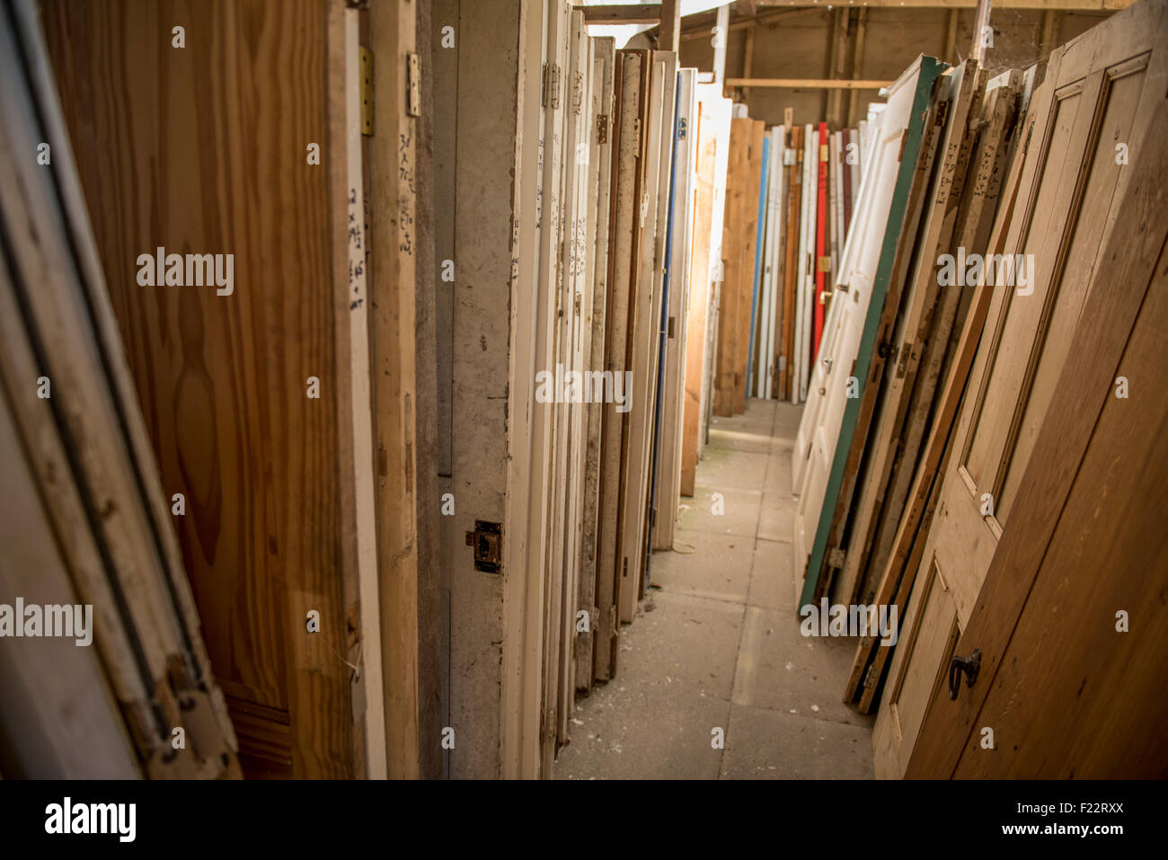 Selection of used doors available for sale at an architectural salvage yard in East Sussex, England, UK. Stock Photo