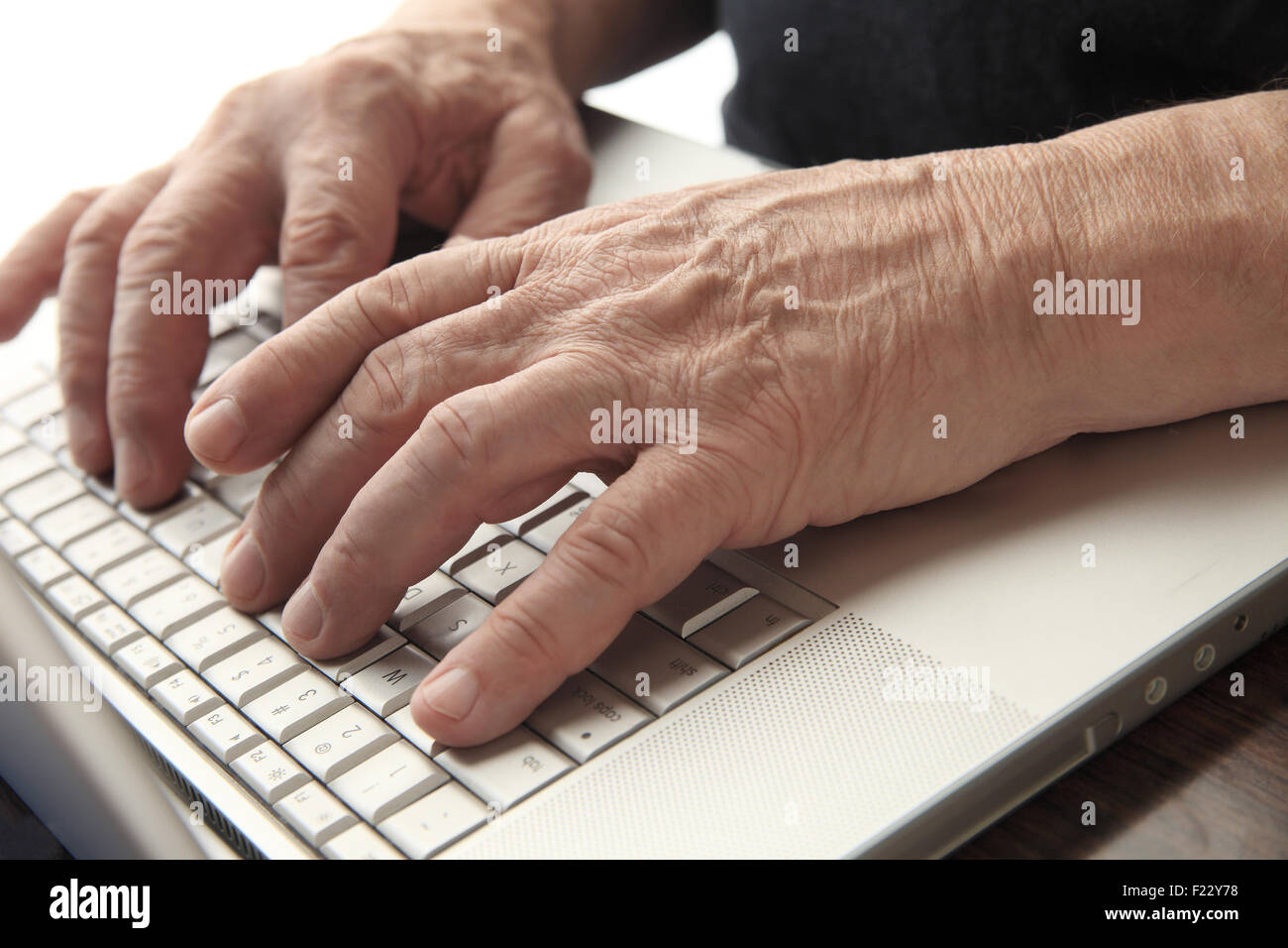 Senior man works at his computer. Stock Photo