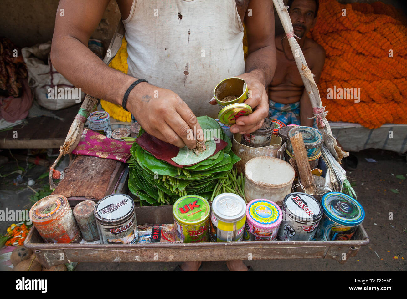 Detail of a paan vendor preparing a mixture of tobacco and areca nut on a betel leaf, in Calcutta (Kolkata) Stock Photo
