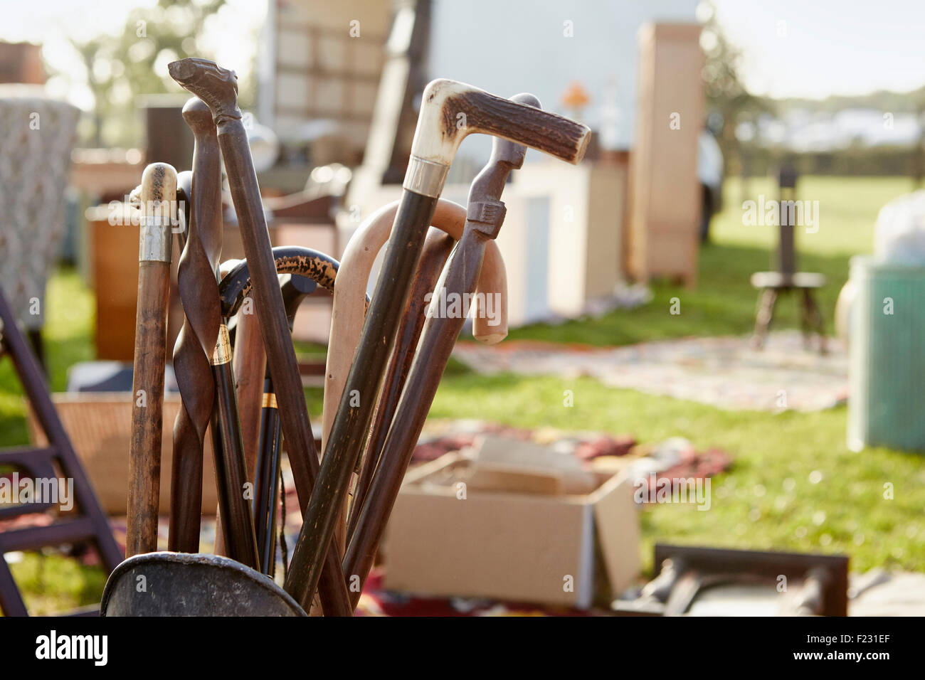 Selection of wooden canes and walking sticks for sale at an open air flea market stall. Stock Photo
