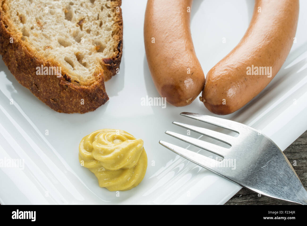Frankfurter sausages with fork, bread and mustard Stock Photo Alamy