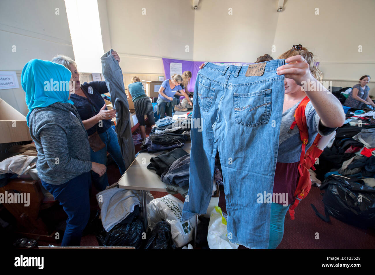 Exeter, UK. 10th Sep, 2015. Trouser checking during the Exeter Calais Solidarity collection for refugees living in 'The Jungle' refguee camp in Calais Credit:  Clive Chilvers/Alamy Live News Stock Photo