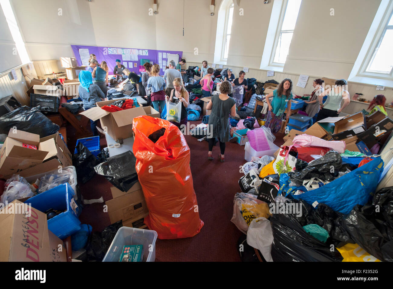 Exeter, UK. 10th Sep, 2015. The Quaker Meeting Hall is filled with clothes and volunteers during the Exeter Calais Solidarity collection for refugees living in 'The Jungle' refguee camp in Calais Credit:  Clive Chilvers/Alamy Live News Stock Photo