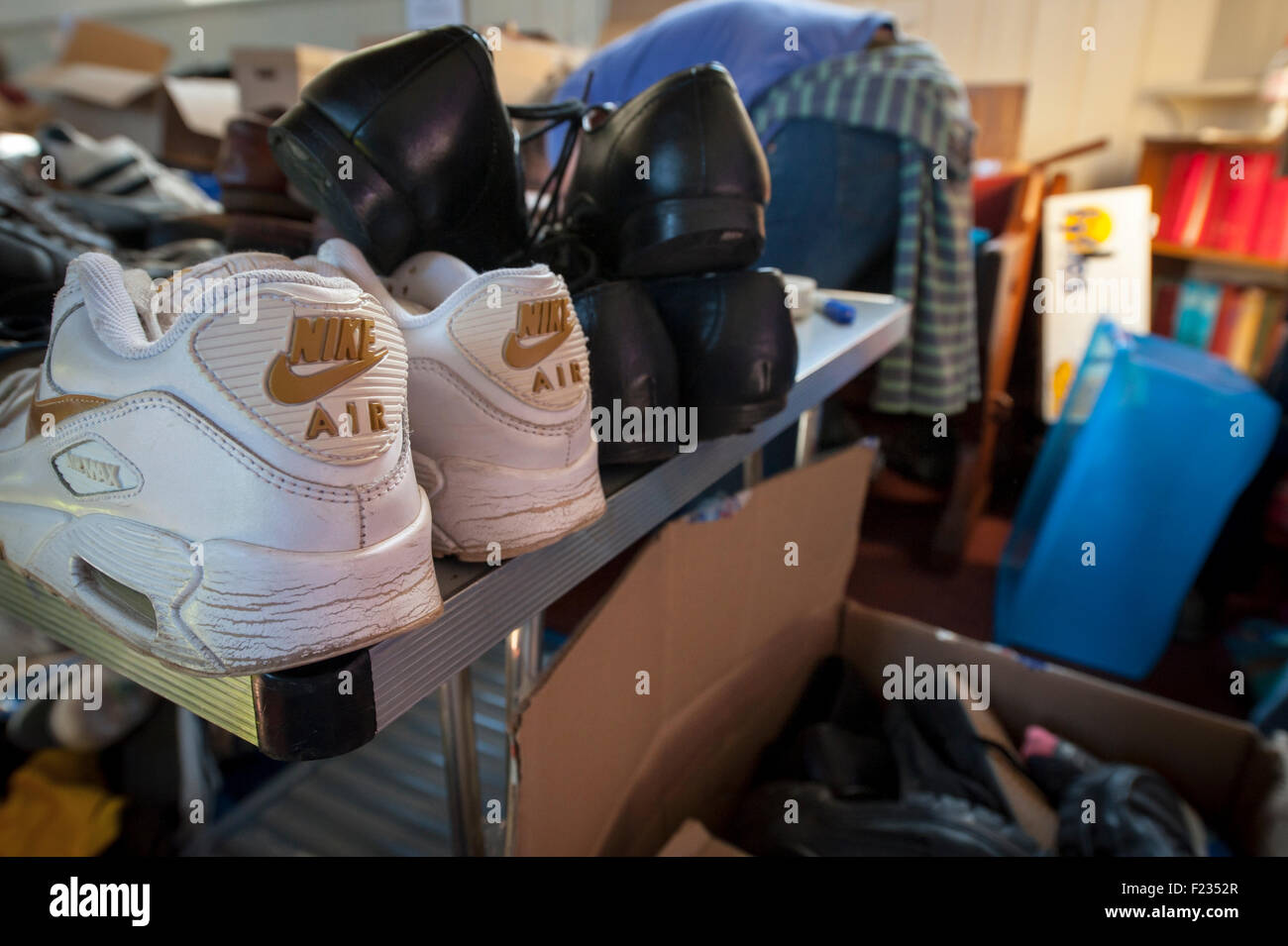 Exeter, UK. 10th Sep, 2015. A pair of Nike Air trainers are donated at the Exeter Calais Solidarity collection for refugees living in 'The Jungle' refguee camp in Calais Credit:  Clive Chilvers/Alamy Live News Stock Photo