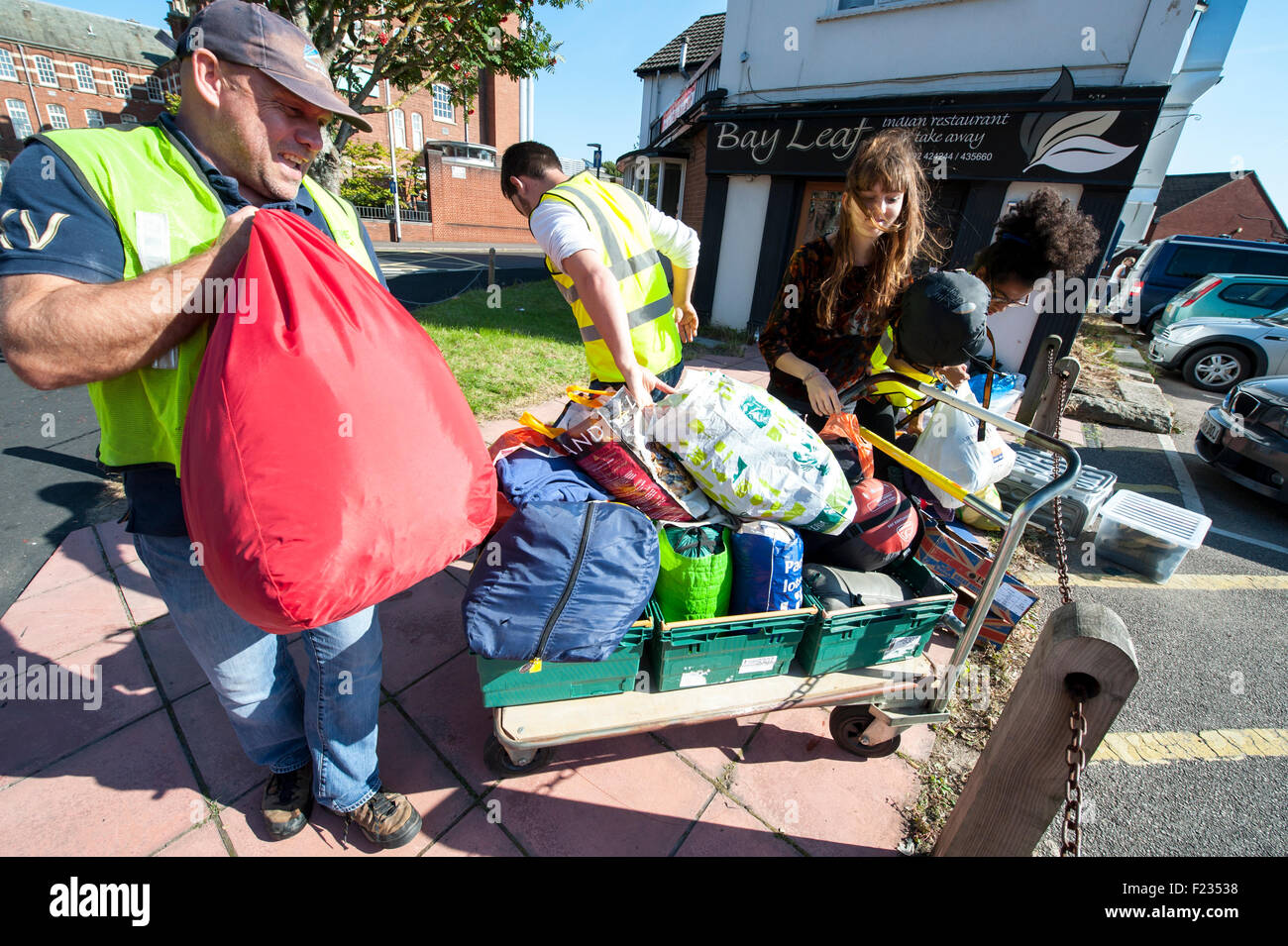 Exeter, UK. 10th Sep, 2015. A trolly is filled with clothes at a car park donation point during the Exeter Calais Solidarity collection for refugees living in 'The Jungle' refguee camp in Calais Credit:  Clive Chilvers/Alamy Live News Stock Photo