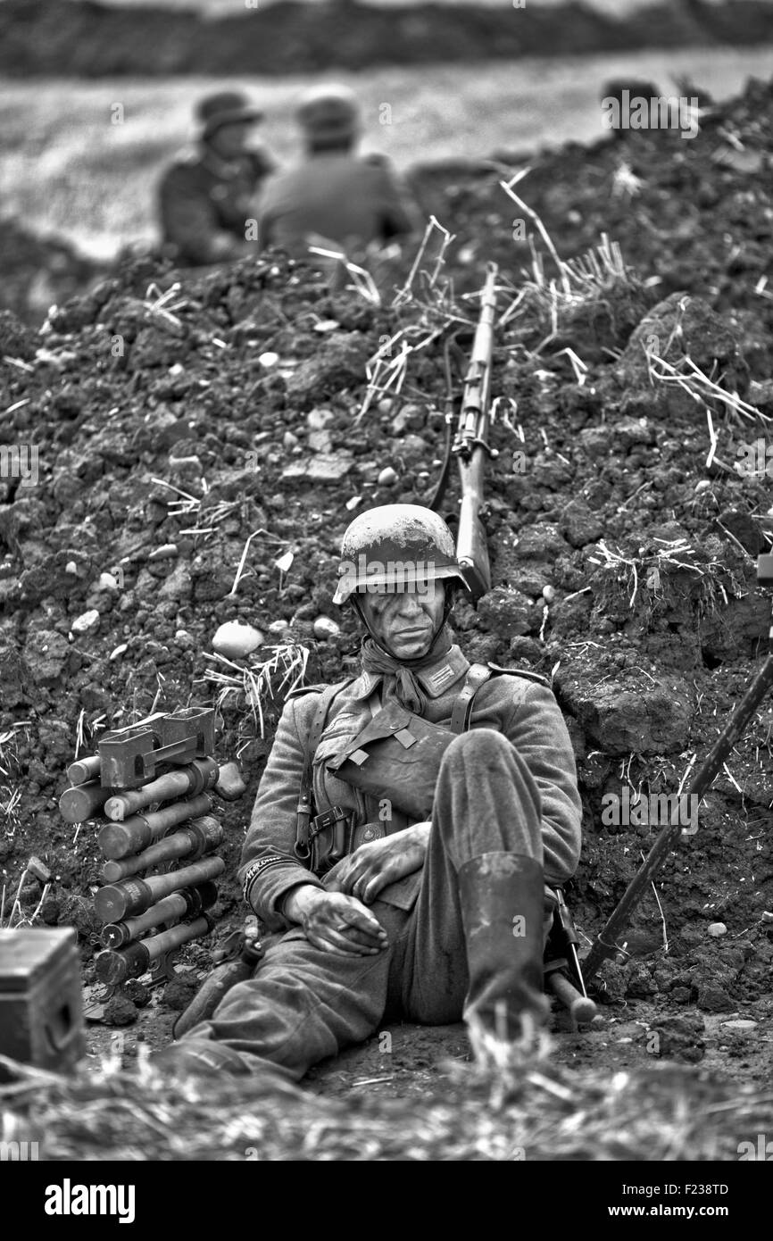 World war 11 soldier sitting in the trenches on a battlefield Stock Photo