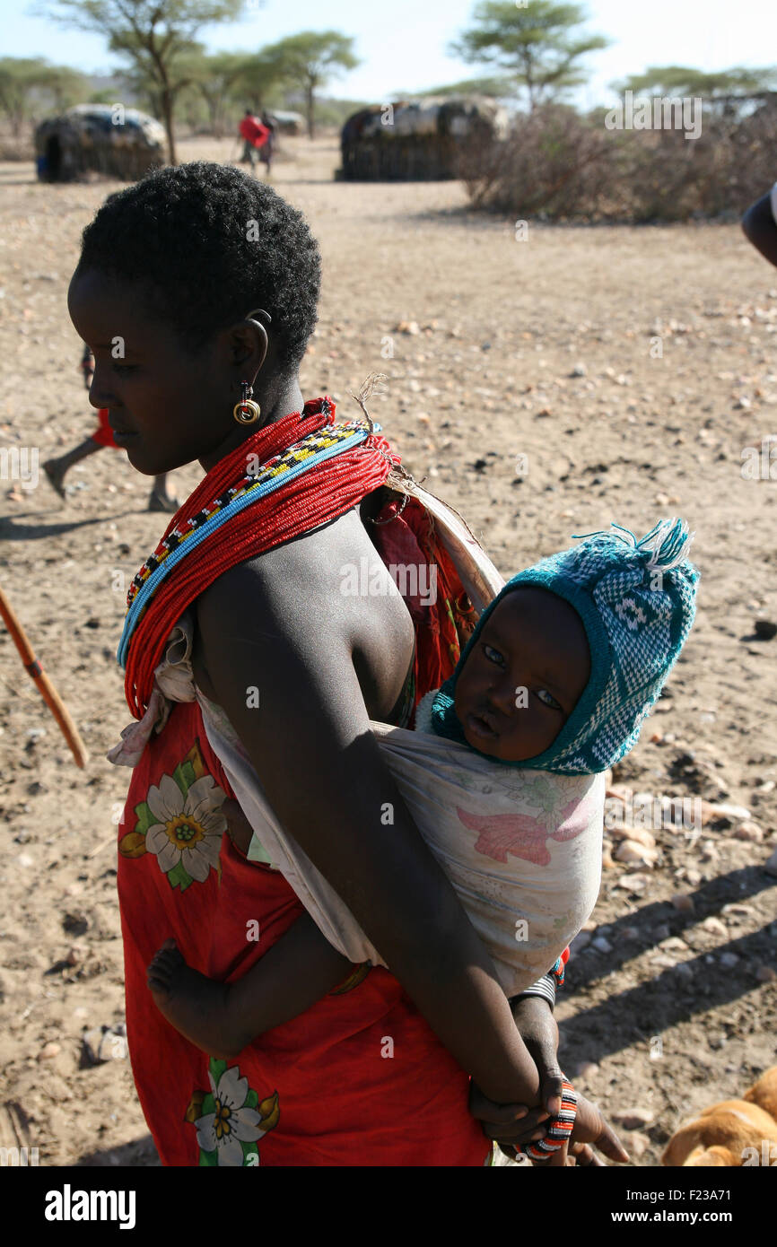 African woman carrying her baby from Samburu tribe in a local village of Kenya Stock Photo
