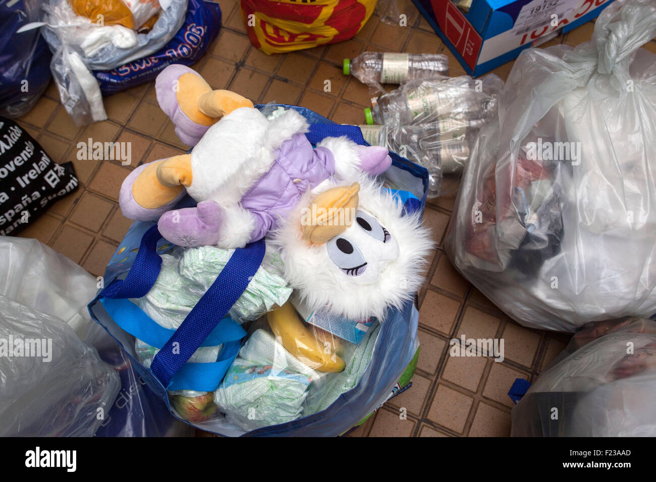 Copenhagen, Denmark, September 10th, 2015. A donated dull is ready for a refugee child in Copenhagen Railroad Station. Many people donated all sorts of things the refugees might need for their short onward travel to Sweden. I the main hall a packing area was organised. Credit:  OJPHOTOS/Alamy Live News Stock Photo