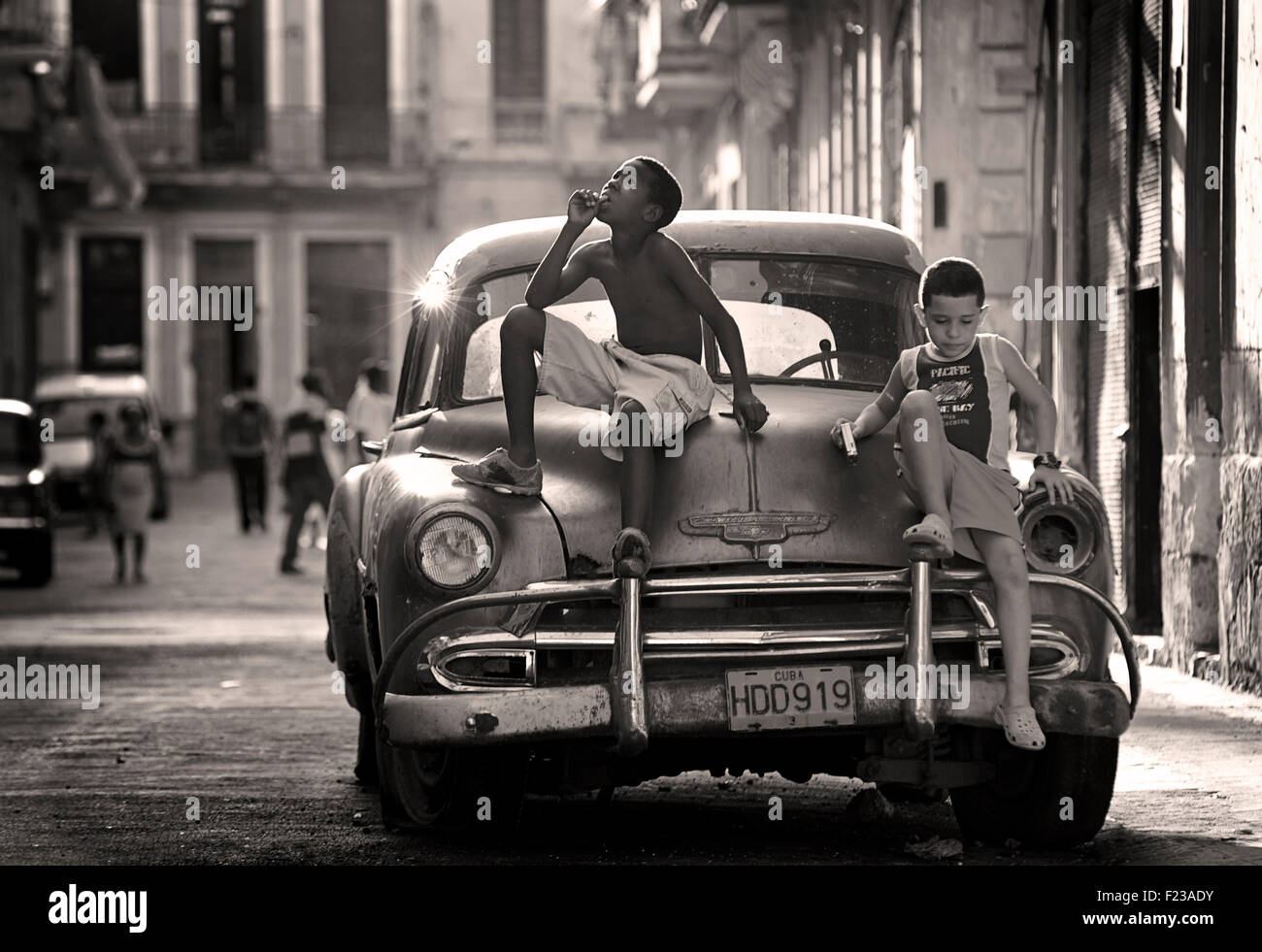 Cuban kids on a classic American car. CHEVROLET. A cultural icon for modern day Cuba. Havana, Cuba. Stock Photo