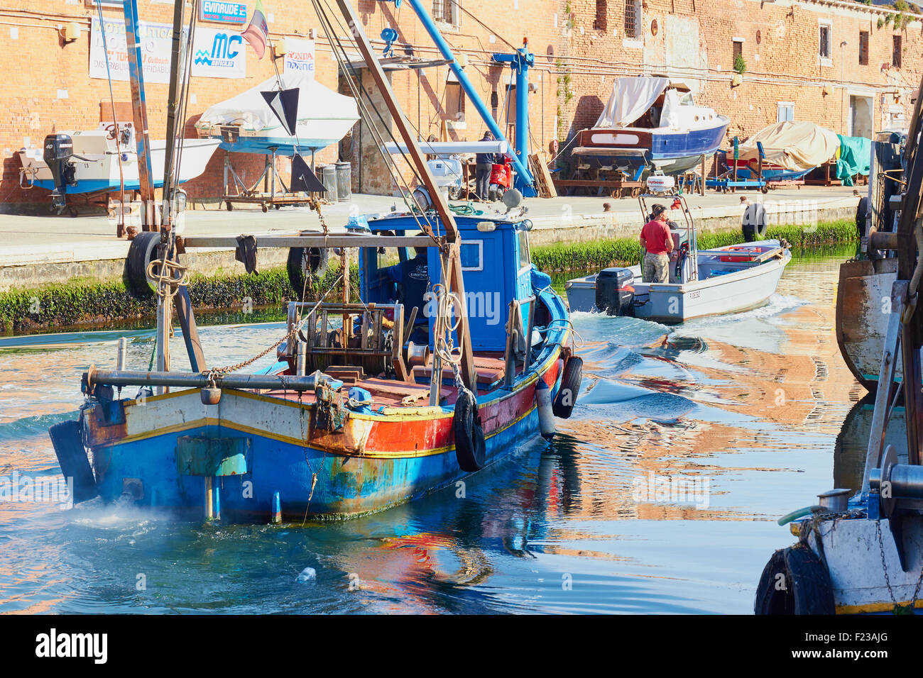 Fishing trawler travelling along canal Chioggia Venetian Lagoon Veneto Italy Europe Stock Photo