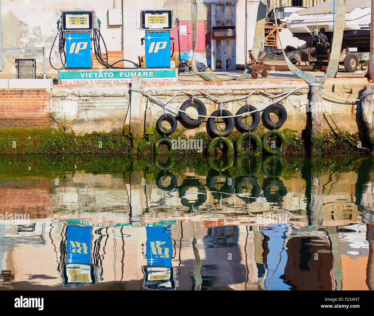 Canalside scene with fuel pumps and reflections Chioggia Venetian Lagoon Veneto Italy Europe Stock Photo