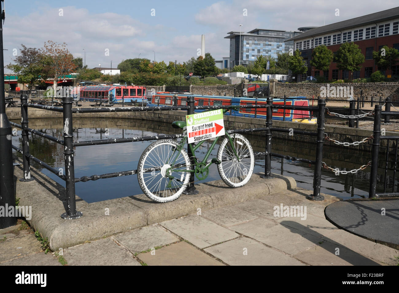 Old Bicycle used as Advertisement, Victoria Quays Sheffield canal wharf basin, England UK Stock Photo