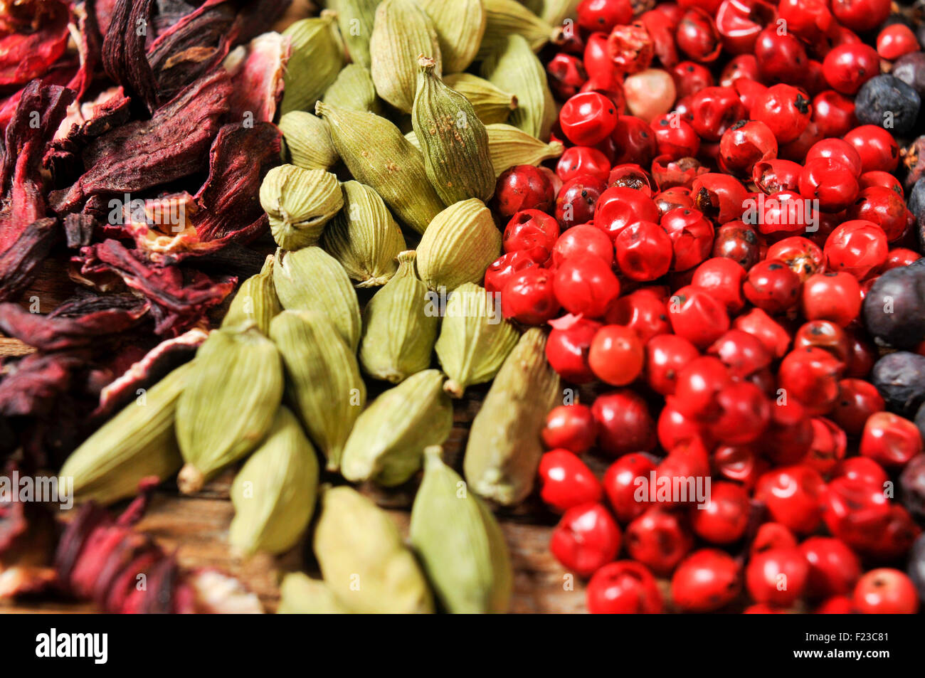 closeup of a pile of dried hibiscus flowers, green cardamom, pink