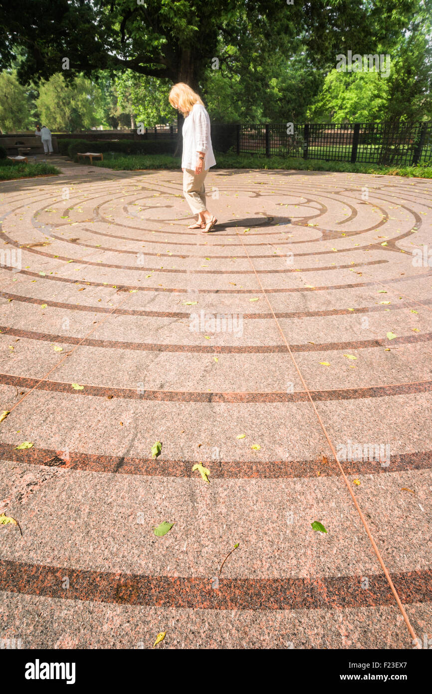Blond woman walks the circular path at Cathedral Labyrinth, New Harmony, IN Stock Photo
